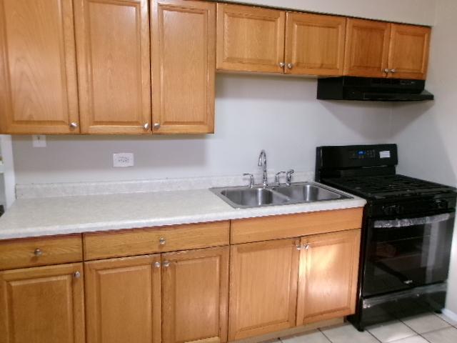 14624 Peoria St, Harvey, IL 60426 - kitchen featuring light countertops, exhaust hood, a sink, and black range with gas stovetop