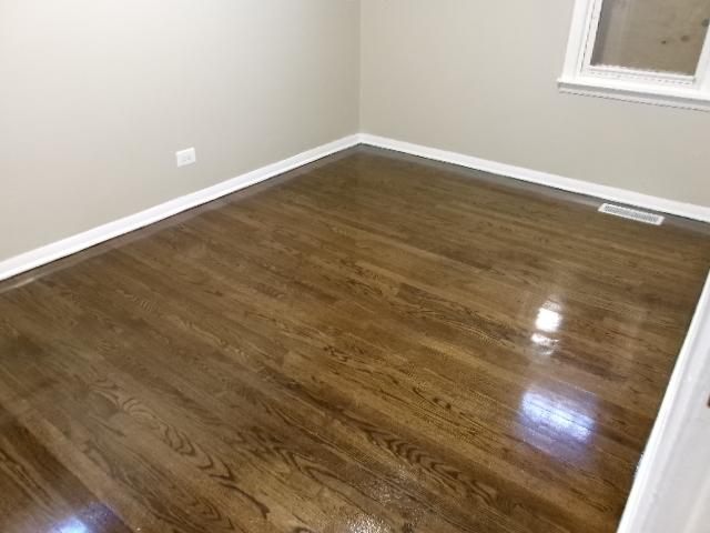 empty room with visible vents, dark wood-style floors, and baseboards