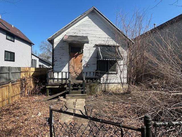 back of house with fence