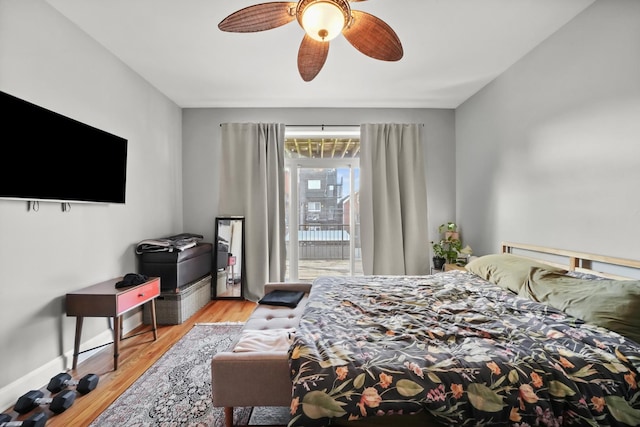 bedroom with ceiling fan, baseboards, and wood finished floors