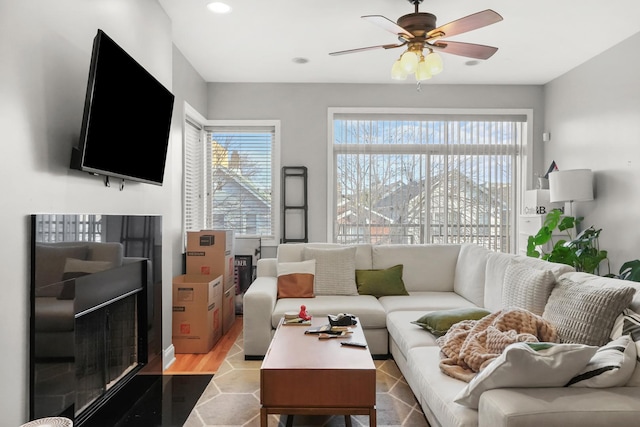 living room featuring plenty of natural light, recessed lighting, ceiling fan, and wood finished floors