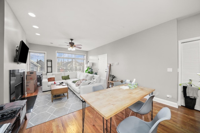 living area with ceiling fan, baseboards, wood finished floors, and recessed lighting