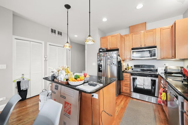 kitchen with visible vents, light wood-style flooring, recessed lighting, stainless steel appliances, and a center island