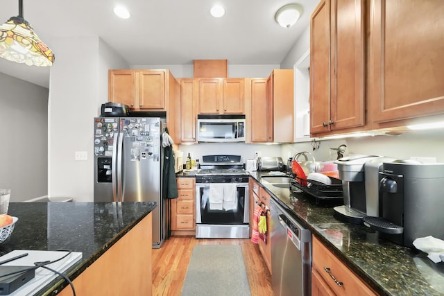 kitchen featuring recessed lighting, light wood-type flooring, appliances with stainless steel finishes, and a sink