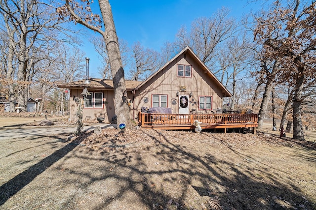 rear view of property featuring a wooden deck