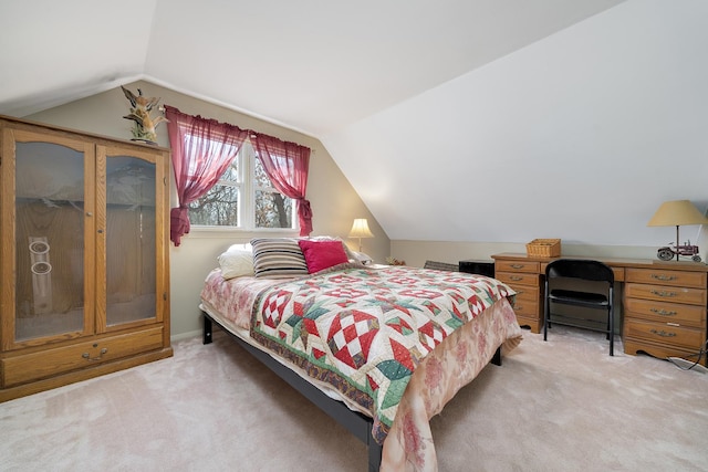 bedroom featuring light carpet and lofted ceiling