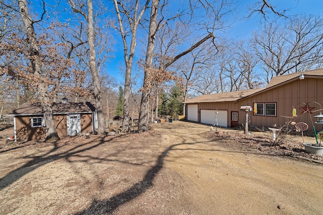 view of side of home featuring a garage and driveway