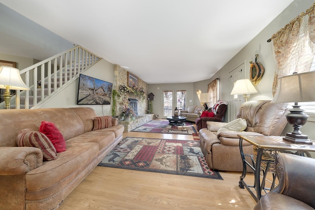 living area with stairs and wood finished floors