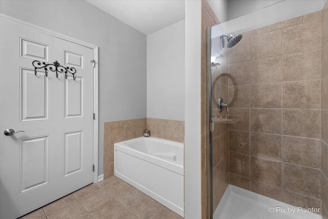 bathroom featuring tile patterned floors, a garden tub, and a stall shower