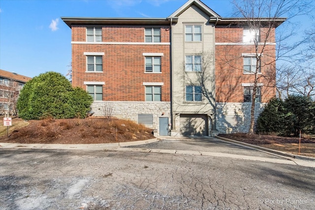 view of building exterior with a garage and driveway