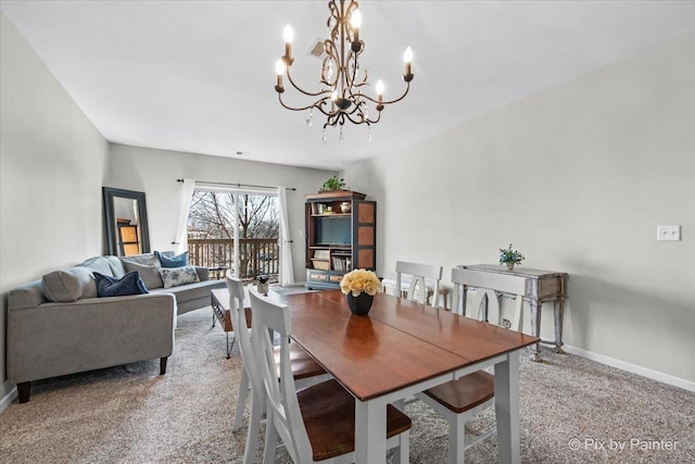 carpeted dining area featuring baseboards