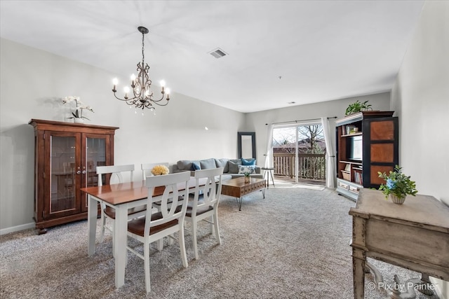 carpeted dining room with a chandelier, visible vents, and baseboards