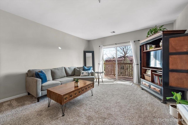 carpeted living room with visible vents and baseboards