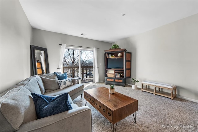 carpeted living area with baseboards