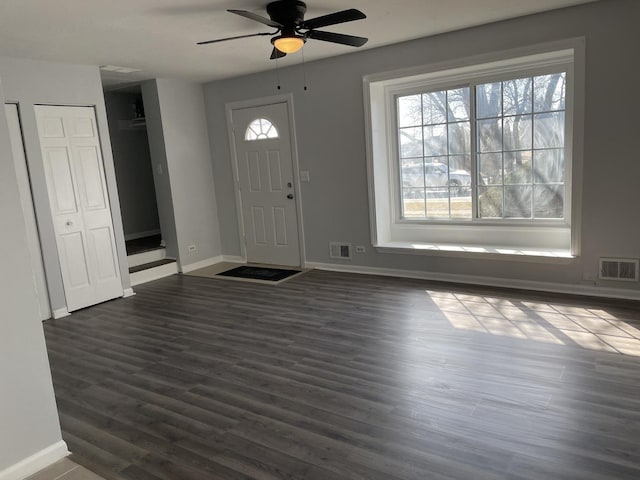 entrance foyer with visible vents, baseboards, dark wood-style floors, and a ceiling fan