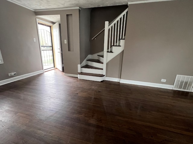 interior space with stairs, visible vents, baseboards, and dark wood-style flooring