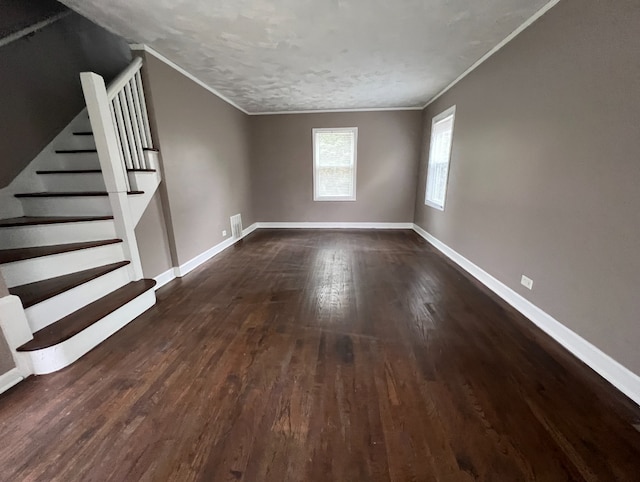 unfurnished living room with dark wood-style floors, crown molding, stairs, and baseboards