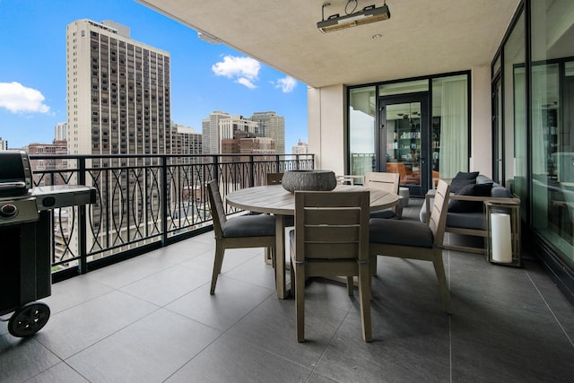 balcony with area for grilling and a city view