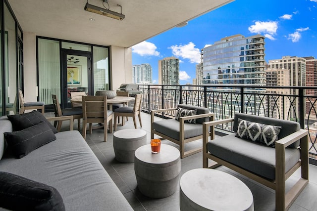 balcony featuring a city view, an outdoor hangout area, and grilling area