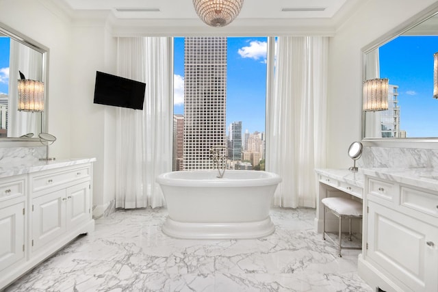 bathroom featuring a freestanding tub, marble finish floor, visible vents, and vanity