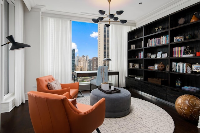 living area with a city view, an inviting chandelier, wood finished floors, and crown molding