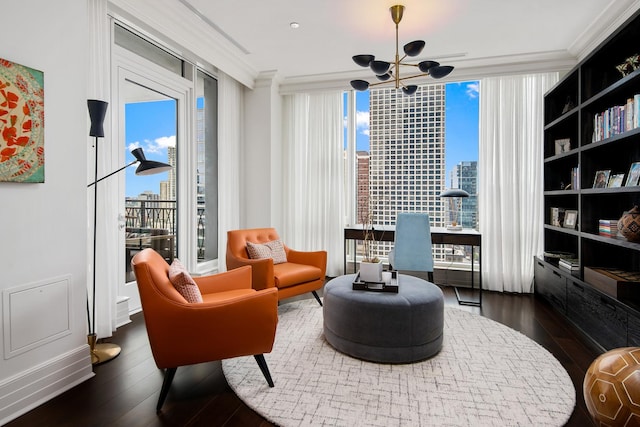 living area featuring plenty of natural light, crown molding, wood-type flooring, and expansive windows