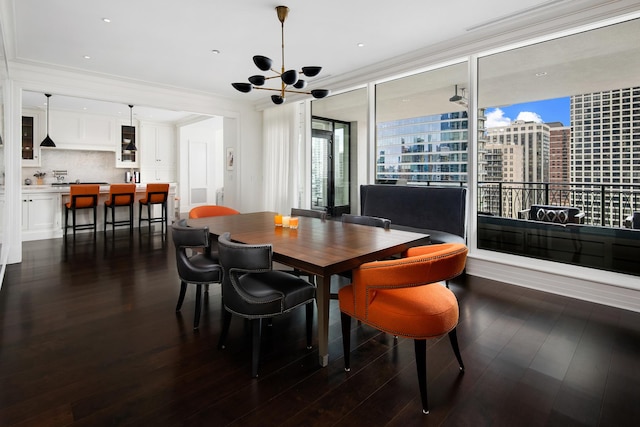 dining room featuring dark wood-type flooring, a view of city, and ornamental molding