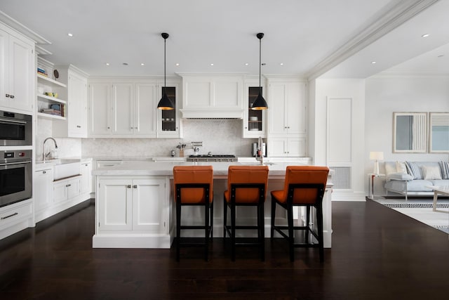 kitchen featuring open shelves, a sink, light countertops, white cabinetry, and backsplash