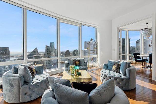 living room featuring a healthy amount of sunlight, a view of city, and wood finished floors