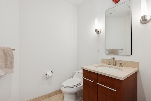 half bathroom featuring tile patterned floors, toilet, vanity, and baseboards