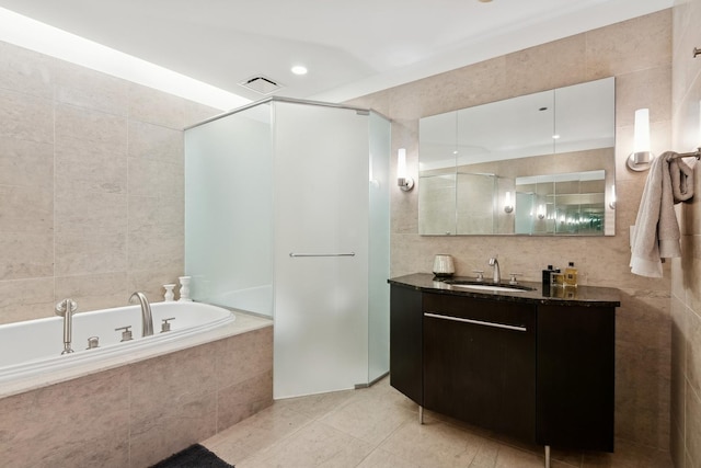 full bath featuring a garden tub, tile walls, and a stall shower