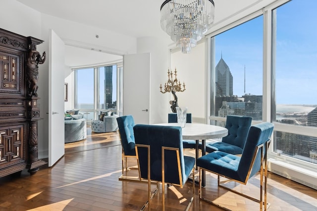 dining area with a city view, hardwood / wood-style flooring, and a notable chandelier