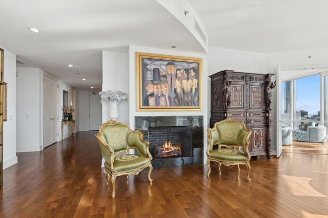 sitting room featuring recessed lighting, hardwood / wood-style floors, and a tile fireplace