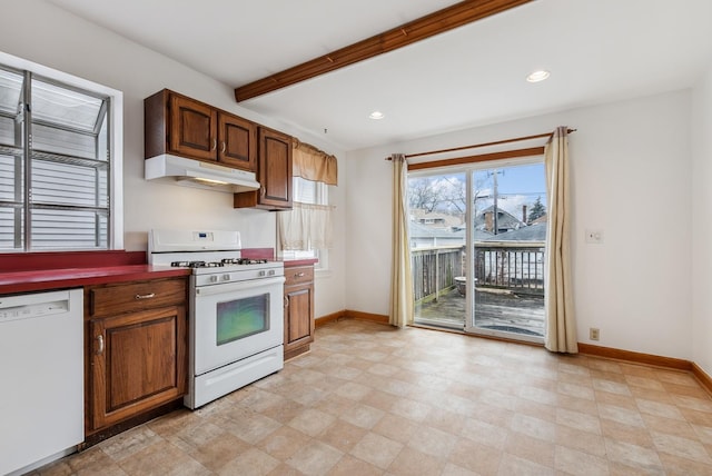 kitchen with white appliances, beamed ceiling, baseboards, and under cabinet range hood