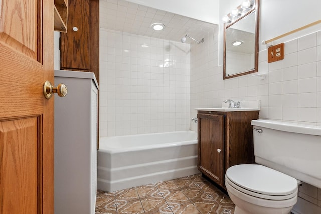 full bathroom with tile walls, toilet, bathtub / shower combination, tile patterned floors, and vanity