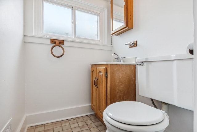 half bath with tile patterned floors and vanity