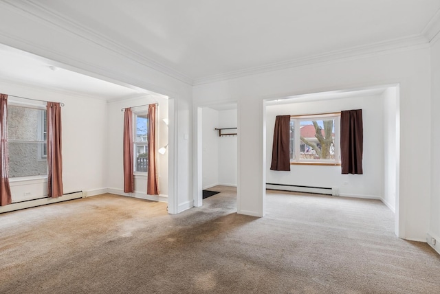 carpeted spare room featuring a baseboard radiator, baseboards, a healthy amount of sunlight, and crown molding