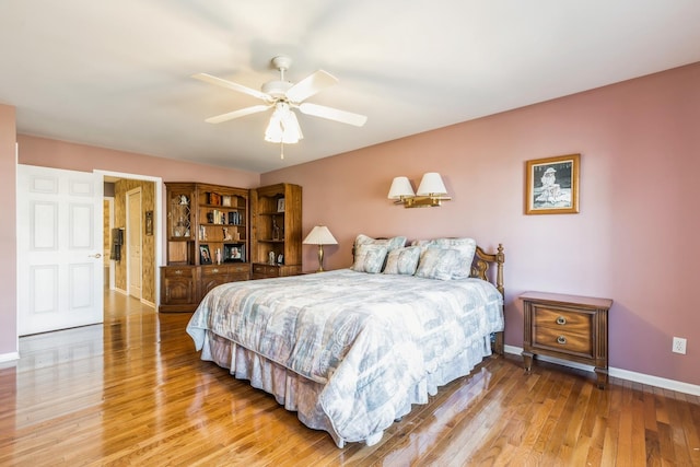 bedroom featuring a ceiling fan, baseboards, and light wood-type flooring