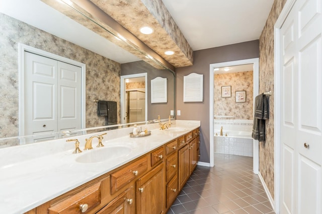 full bathroom with a sink, double vanity, a bath, and tile patterned floors