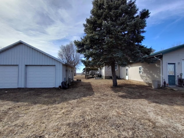 view of yard featuring an outbuilding and a detached garage