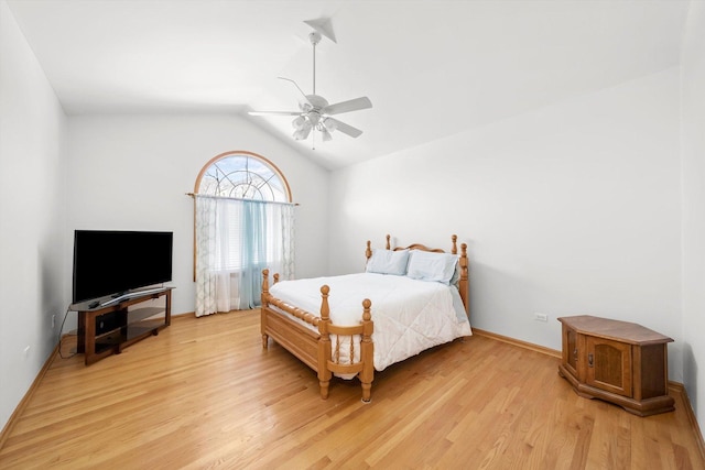 bedroom with baseboards, a ceiling fan, vaulted ceiling, and light wood finished floors