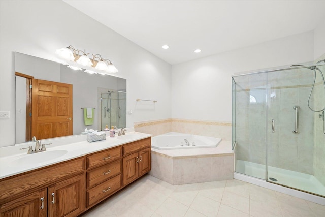 bathroom featuring a garden tub, a stall shower, tile patterned floors, and a sink