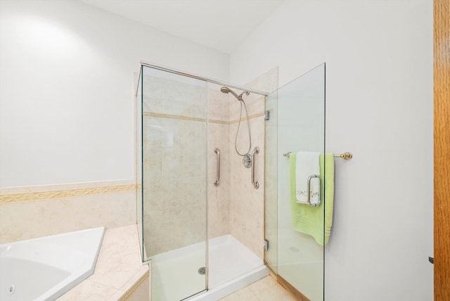 bathroom with a tub with jets and a stall shower