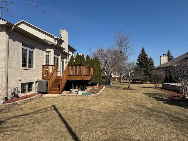 view of yard featuring stairway, central AC unit, and a wooden deck