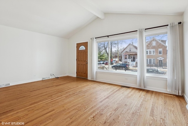 interior space featuring visible vents, baseboards, light wood-style flooring, and vaulted ceiling with beams