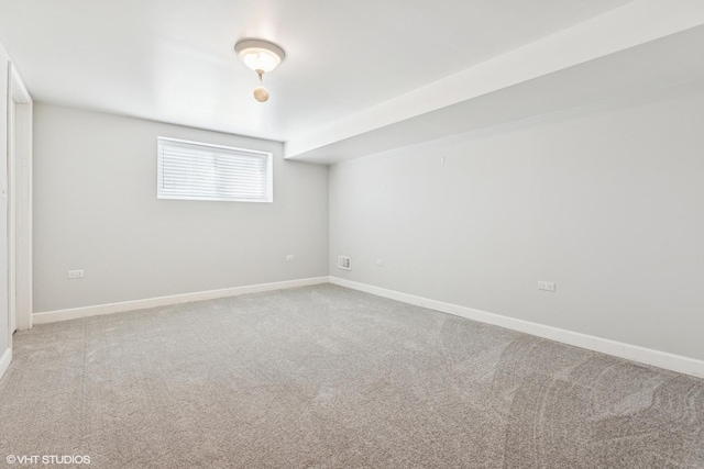 empty room with baseboards and light colored carpet