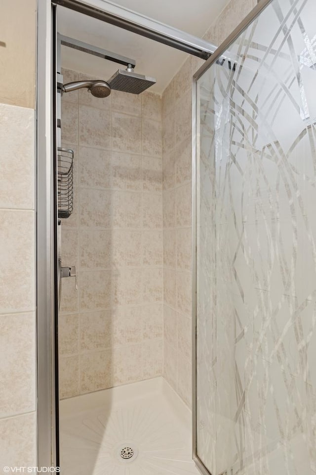 full bath with a shower stall