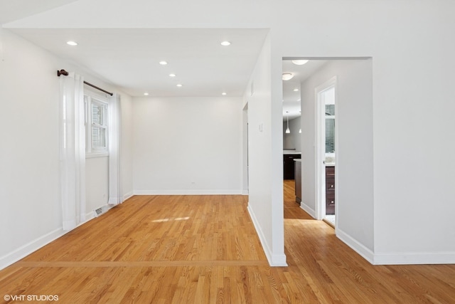 spare room with visible vents, recessed lighting, light wood-type flooring, and baseboards