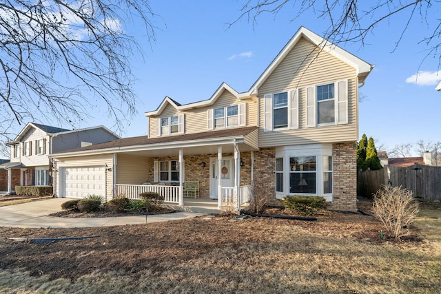 view of front of home featuring brick siding, fence, covered porch, a garage, and driveway