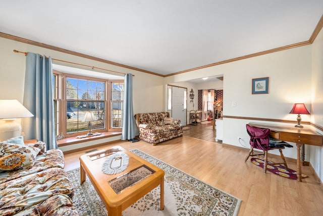 living room featuring crown molding, baseboards, and wood finished floors